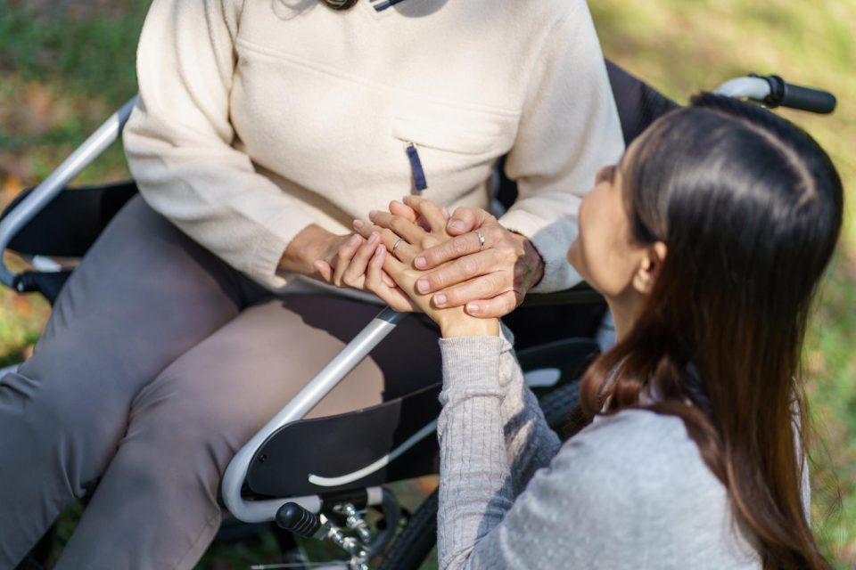 family-relationship-asian-senior-woman-wheelchair-with-happy-daughter-holding-caregiver-hand-while-spending-time-together